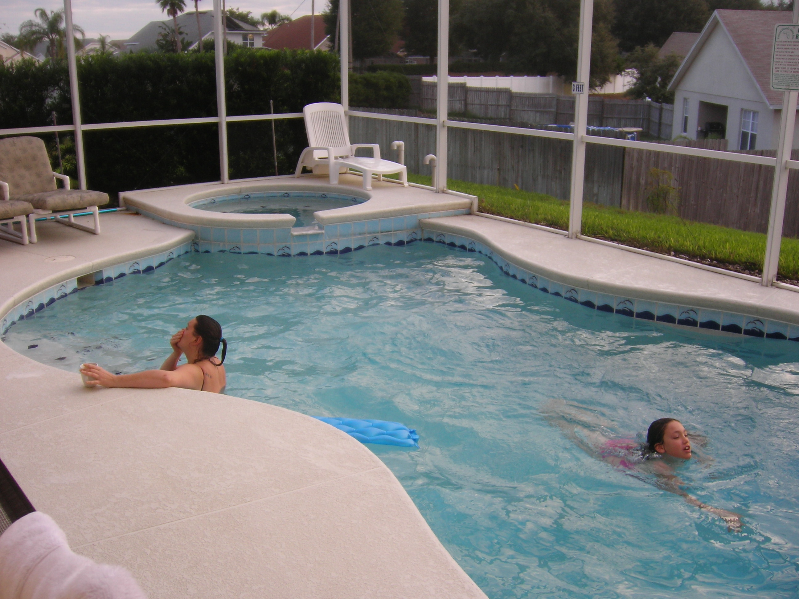 woman and child swimming in villa pool and spa